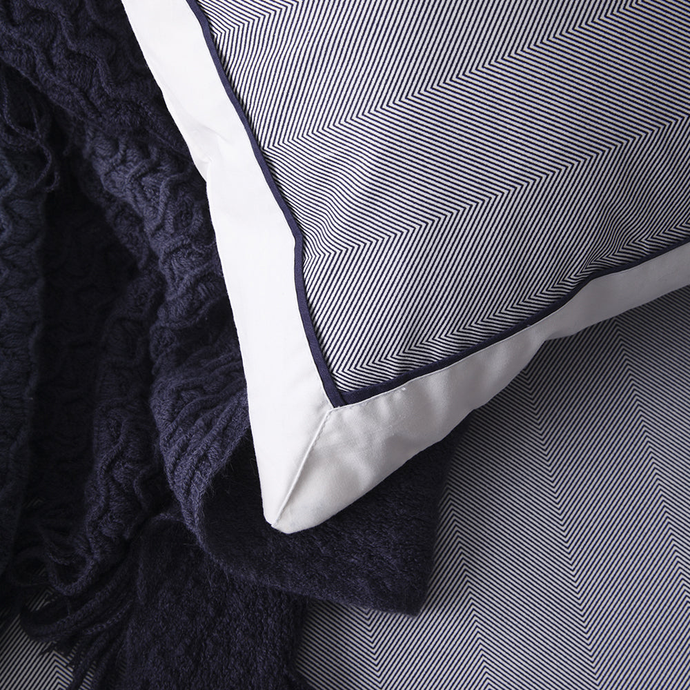 Super King Duvet Cover Set in navy with herringbone pattern, white border, and black piping for elegant bedroom decor.