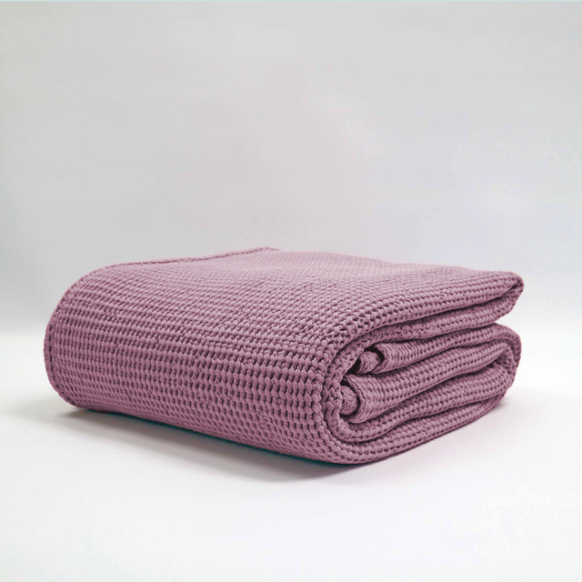 Cozy mauve stonewashed blanket by Baksana, featuring a textured waffle weave, ethically made in Europe.