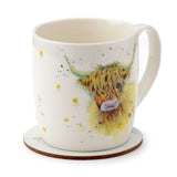 Porcelain mug and cork coaster set featuring a charming Highland cow design, perfect for hot beverages and kitchen décor.