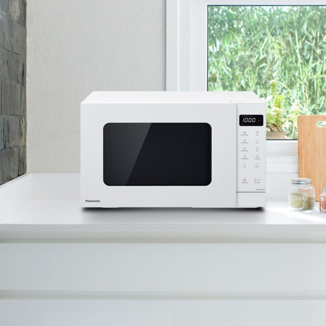 Panasonic NN-ST34NWQPQ microwave oven in white, featuring 900W power, 25L capacity, and sleek push-open design for easy cooking.