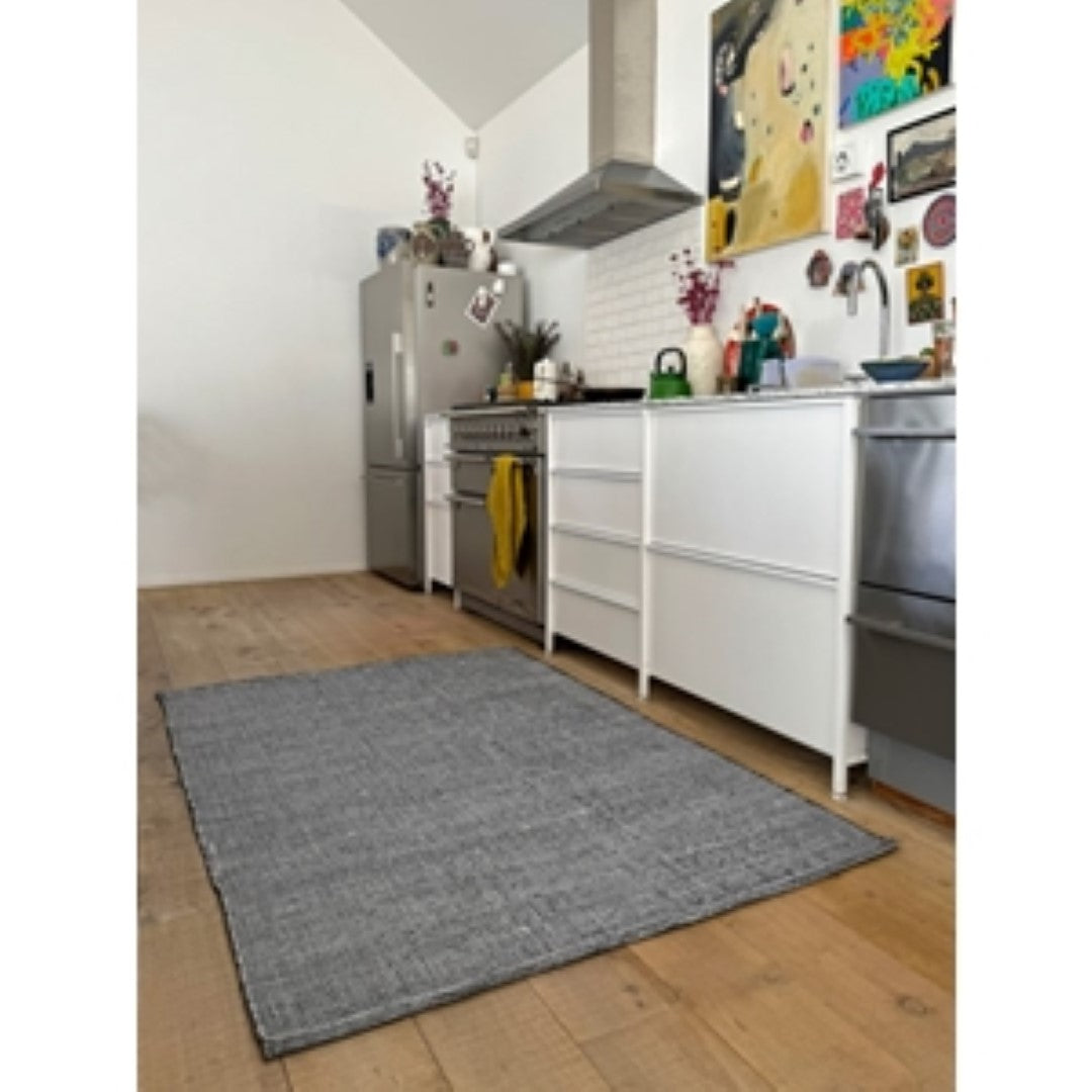 Eco-friendly black marle rug (120 x 180cm) made from recycled PET, perfect for stylish indoor or outdoor spaces.