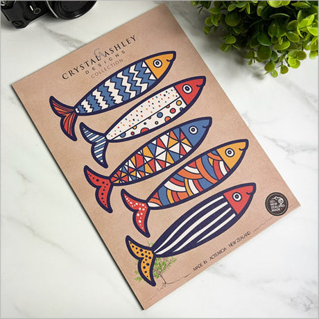 Vibrant wall art set featuring playful fish designs, crafted from durable laser-cut board, perfect for brightening any space.