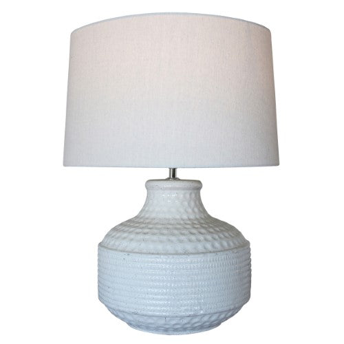 Elegant white terracotta lamp with a natural linen shade, providing soft ambient lighting for any room.