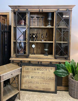 Rustic reclaimed pine wall unit with sliding barn doors, 6 drawers, and 3 shelves, perfect for stylish storage and organization.