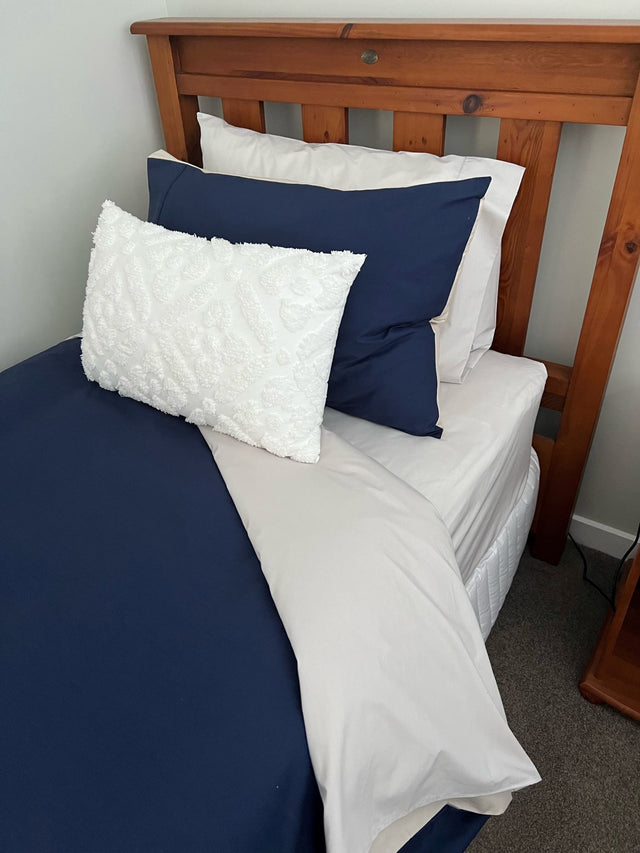 Single duvet cover set in navy/silver, featuring reversible design, soft polycotton blend, and includes pillowcase.