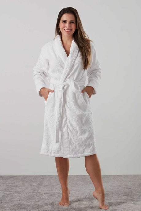 Elegant white jacquard floral robe with shawl collar, two pockets, and waist tie, made from OEKO-TEX® certified cotton.