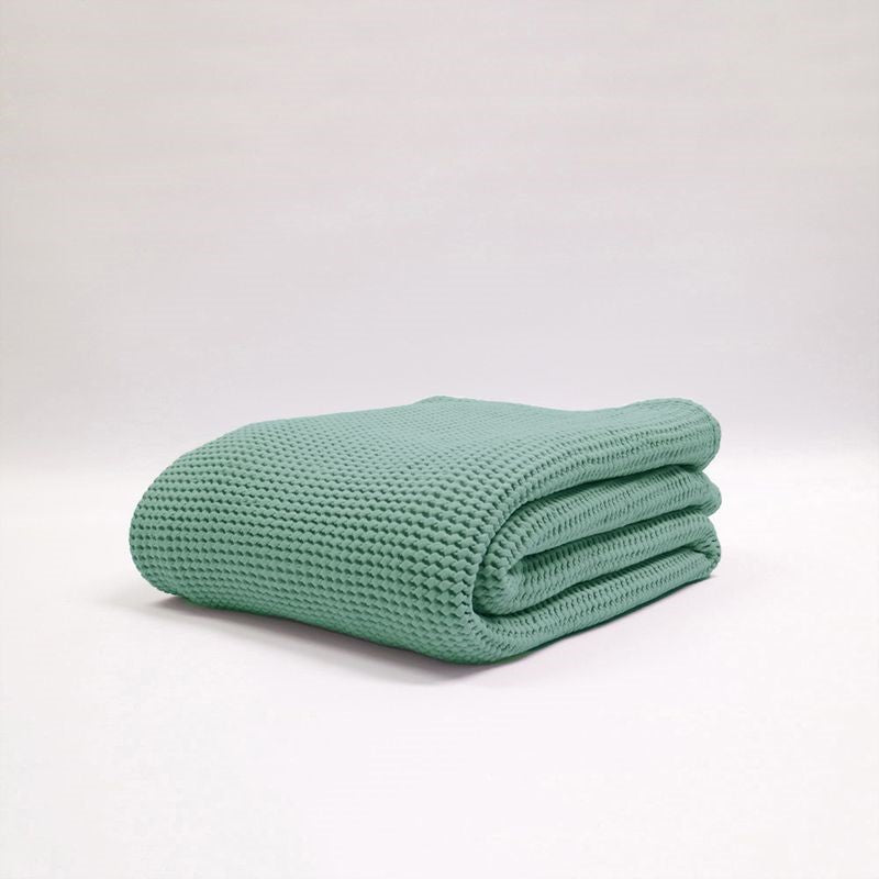 Stonewashed teal blanket by Baksana, featuring a deep waffle texture, ethically made from 100% OEKO-TEX certified cotton.