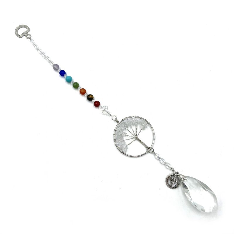 Suncatcher featuring Tree of Life design and clear quartz, promoting throat chakra healing and illuminating spaces beautifully.