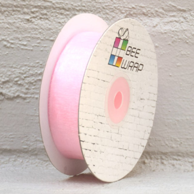 Pale pink organza ribbon, 25mm wide and 50 meters long, perfect for crafting and decor.
