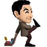 "5-inch Mr Bean vinyl figurine in a corduroy suit, holding an open suitcase with beach tools and Teddy, perfect for collectors."