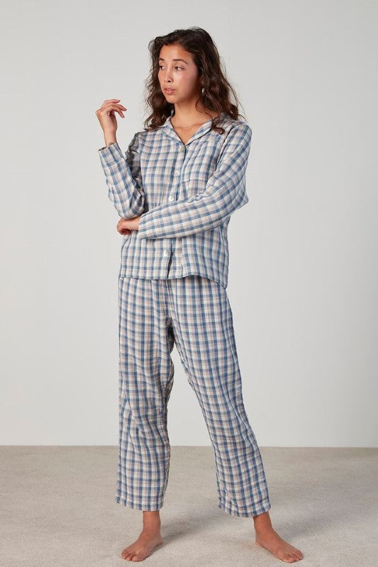 Classic plaid pyjama set featuring a long sleeve button-up top and elasticated pants, made from 100% OEKO-TEX® cotton.