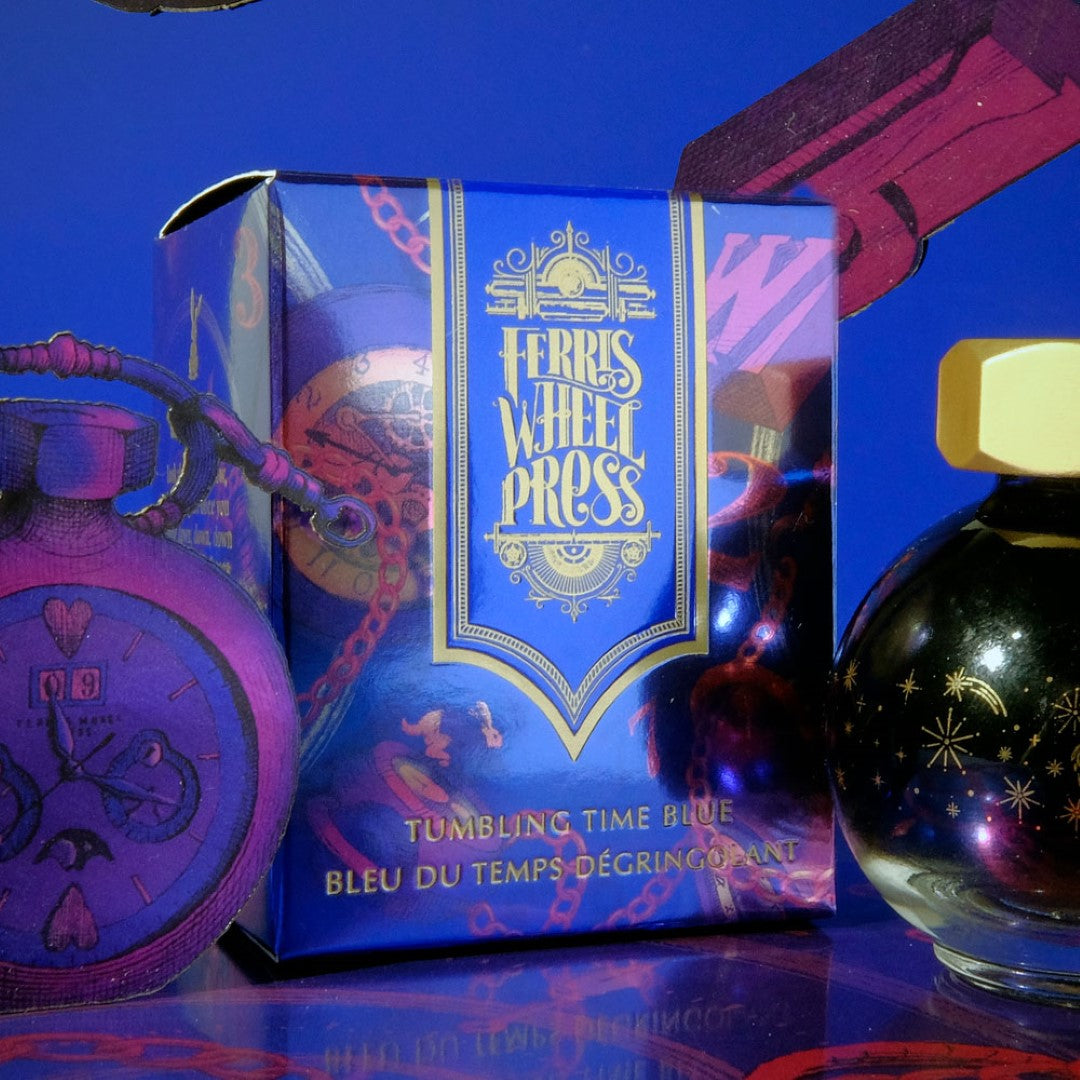 Cobalt blue fountain pen ink with red sheen and silver shimmer in a 20ml decorative glass globe, inspired by Wonderland.