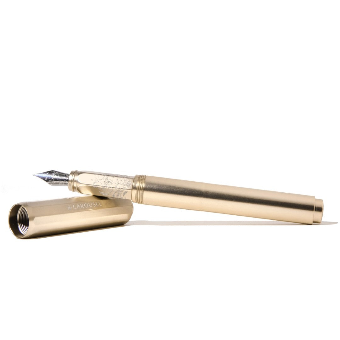 Elegant champagne gold Ferris Wheel Press fountain pen, featuring a fine nib and lightweight aluminum design, ideal for stationery lovers.