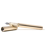 Elegant champagne gold Ferris Wheel Press fountain pen, featuring a fine nib and lightweight aluminum design, ideal for stationery lovers.