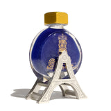 Champagne silver ink carriage stand cradling a 38ml ink bottle, lined with velvet for stability and style.