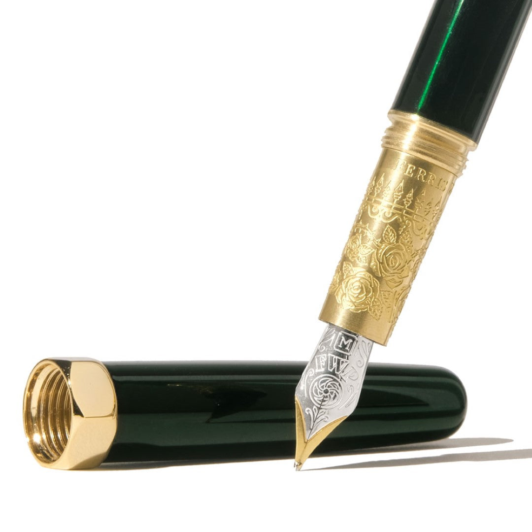 Elegant emerald green fountain pen with a two-tone nib and engraved brass grip, perfect for journaling and letter writing.