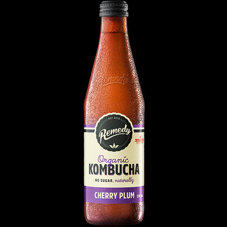 Twelve 330ml bottles of Remedy Cherry Plum Organic Kombucha, showcasing a probiotic-rich, vegan beverage for gut health.