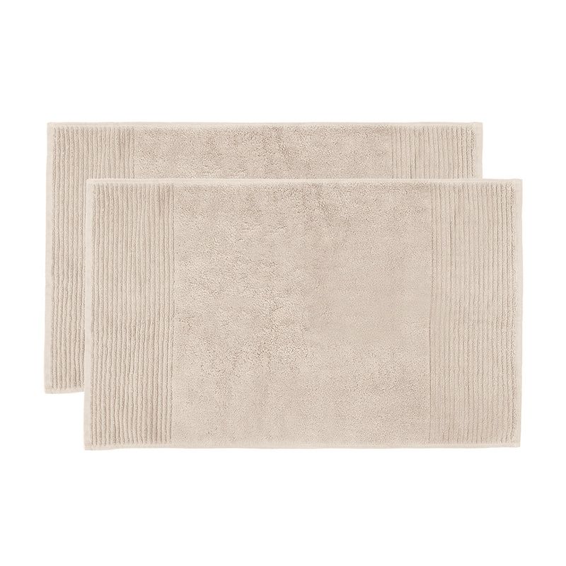 Soft buff bath mat set featuring elegant drop pile stripe design, ultra-absorbent cotton for luxurious bathroom comfort.