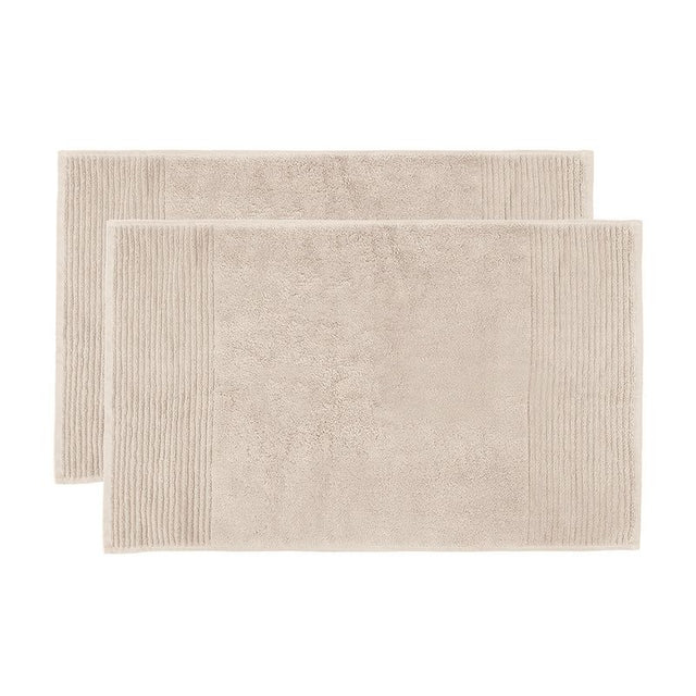 Soft buff bath mat set featuring elegant drop pile stripe design, ultra-absorbent cotton for luxurious bathroom comfort.