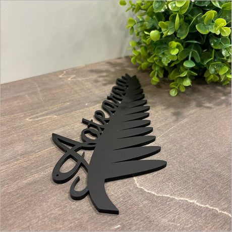 Stylish black acrylic wall art featuring a Silverfern design, perfect for modern decor and easy to mount.