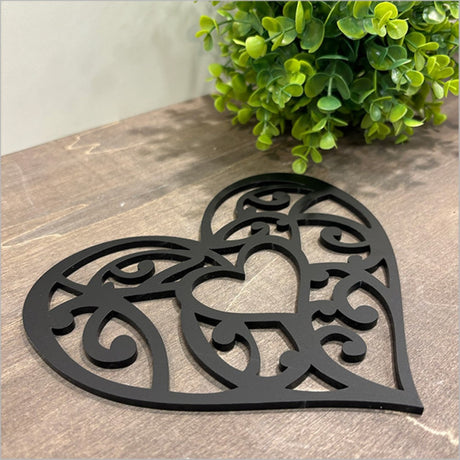 Black acrylic wall art featuring a Kowhaiwhai heart design, symbolizing love and connection, ideal for modern home decor.