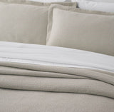 Ecru king bedspread set with textured finish, mitred corners, and Oxford pillowcases, ethically made in Portugal.