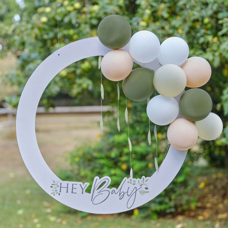 Botanical Baby shower photo booth frame with lush design, balloons, and decorations for memorable party photos.