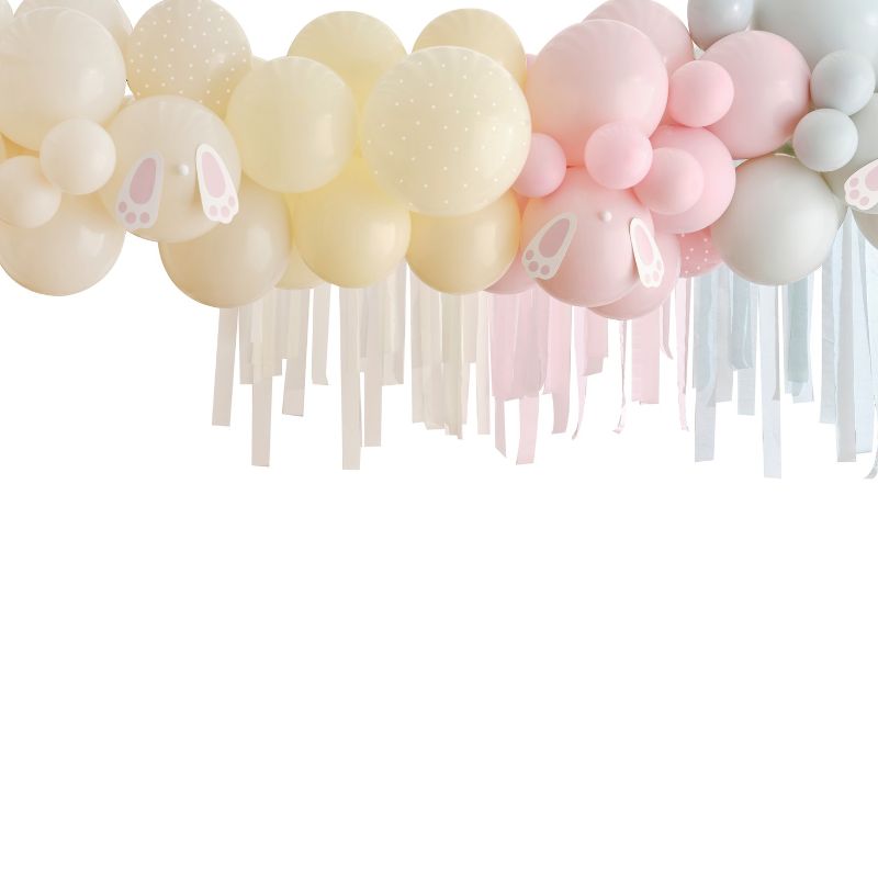 Pastel balloon arch kit with bunny feet decorations, perfect for Easter celebrations and festive photo backdrops.