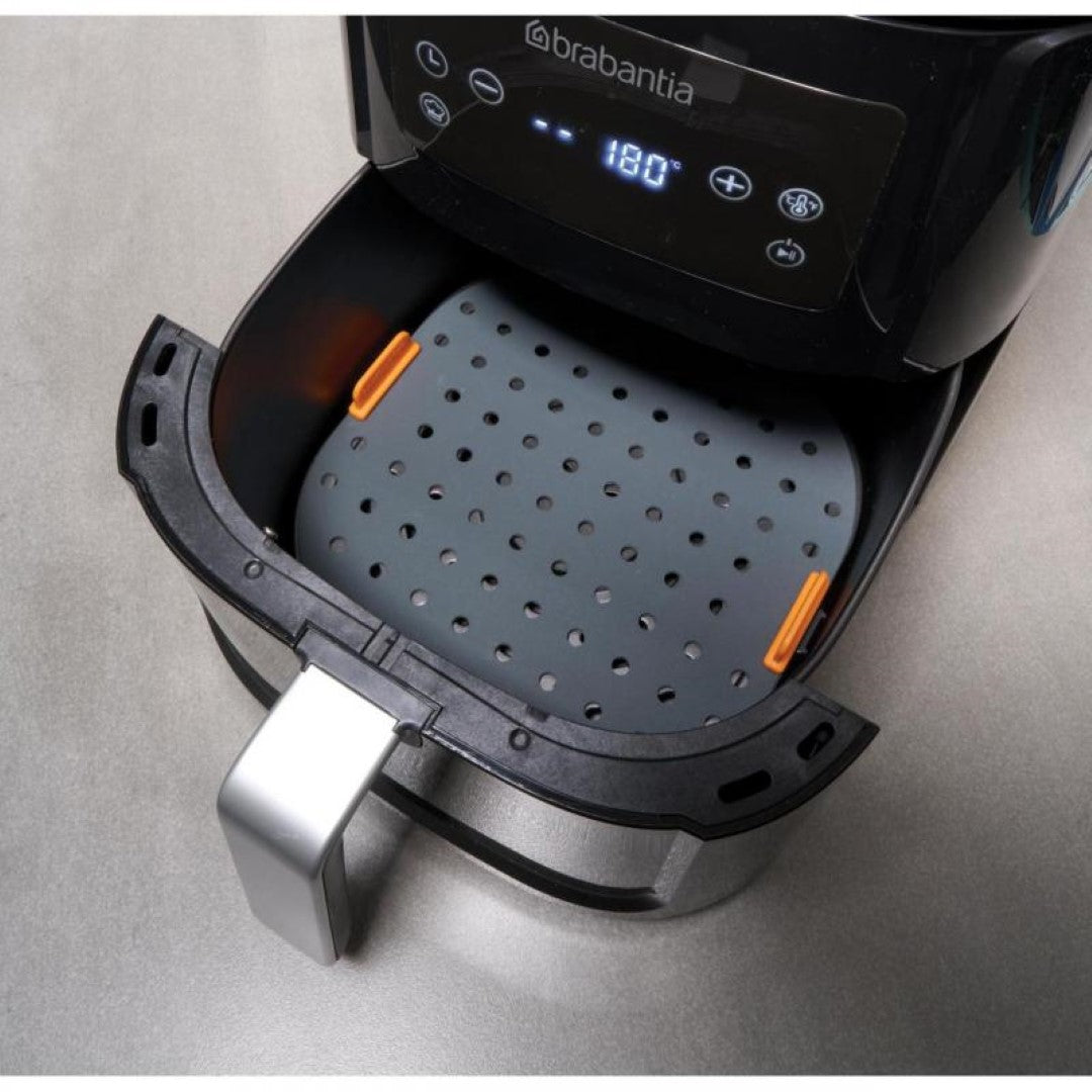 Square silicone air fryer liner (21 x 21cm) with perforations for air circulation, easy lifting tabs, and eco-friendly design.