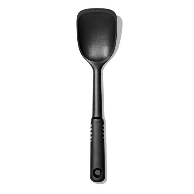 Nylon sauté spoon with a flat edge, designed for non-stick cookware, featuring a comfortable grip and heat resistance up to 450°F.