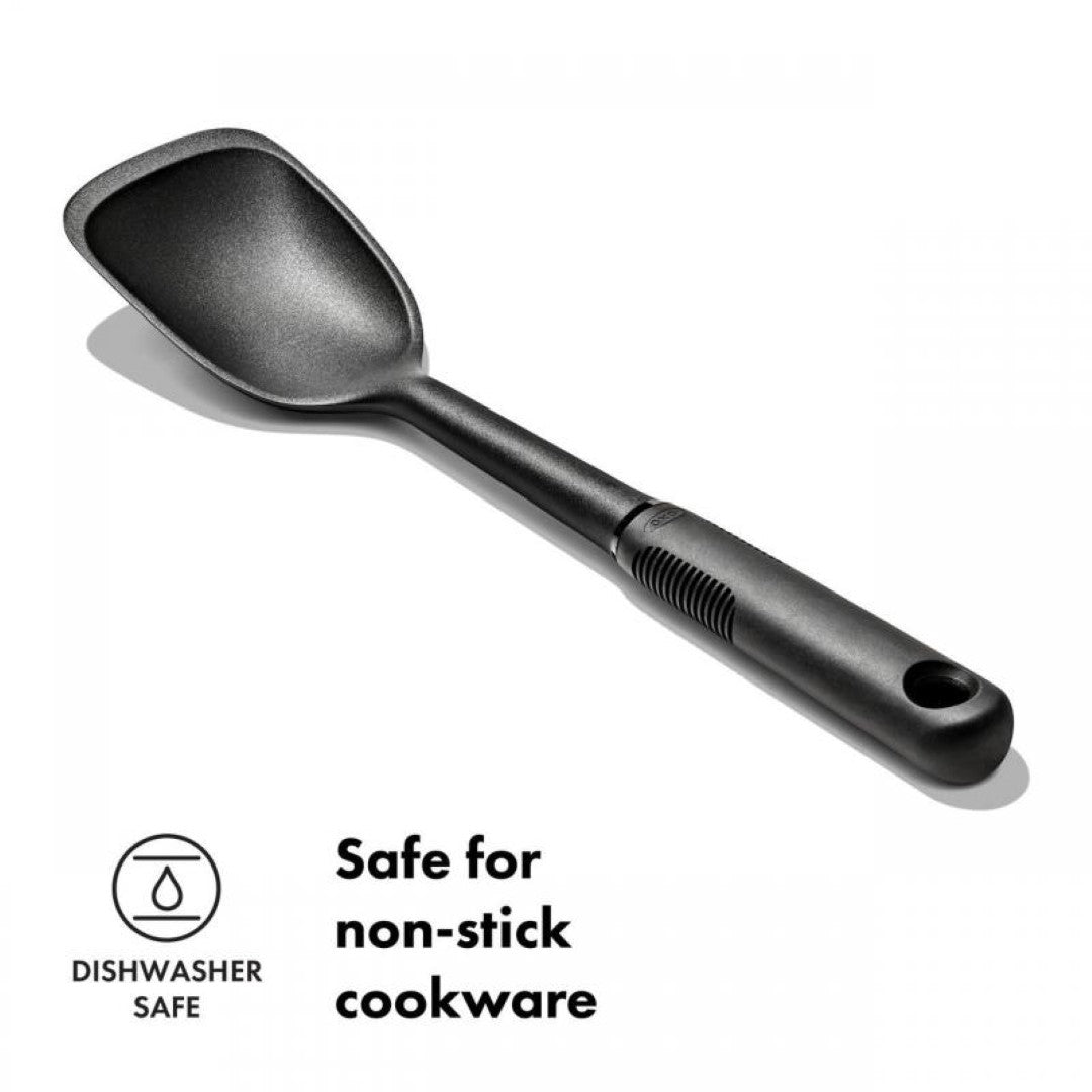 Durable OXO Good Grips Nylon Sauté Spoon with a shallow scoop, flat edge, and comfortable, non-slip handle, safe for non-stick cookware.