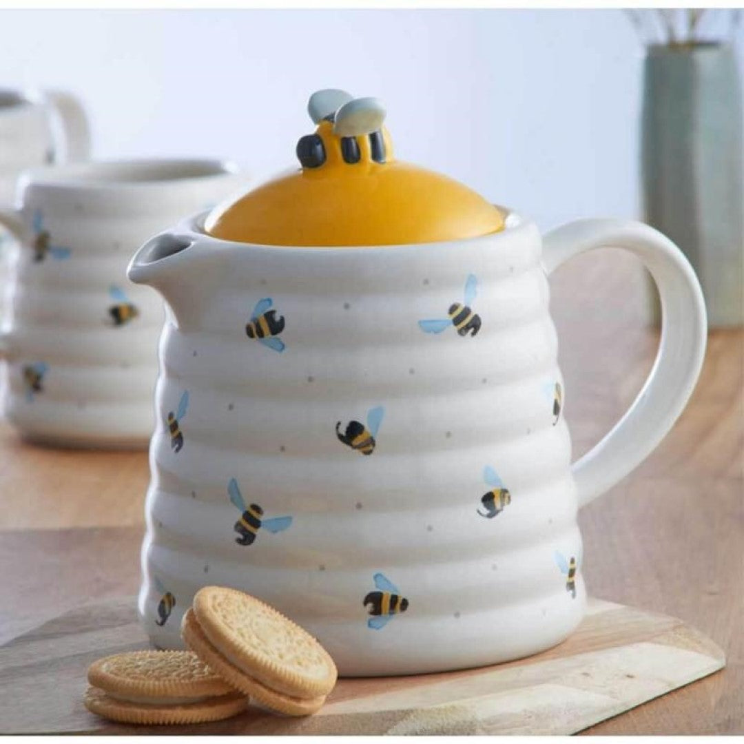 Whimsical teapot with bee hive design, 850ml capacity, non-drip spout, and hand-painted bumble bee handle.