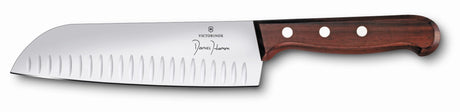 Santoku fluted knife with wooden handle, 17cm blade for effortless slicing of vegetables, meats, and herbs.