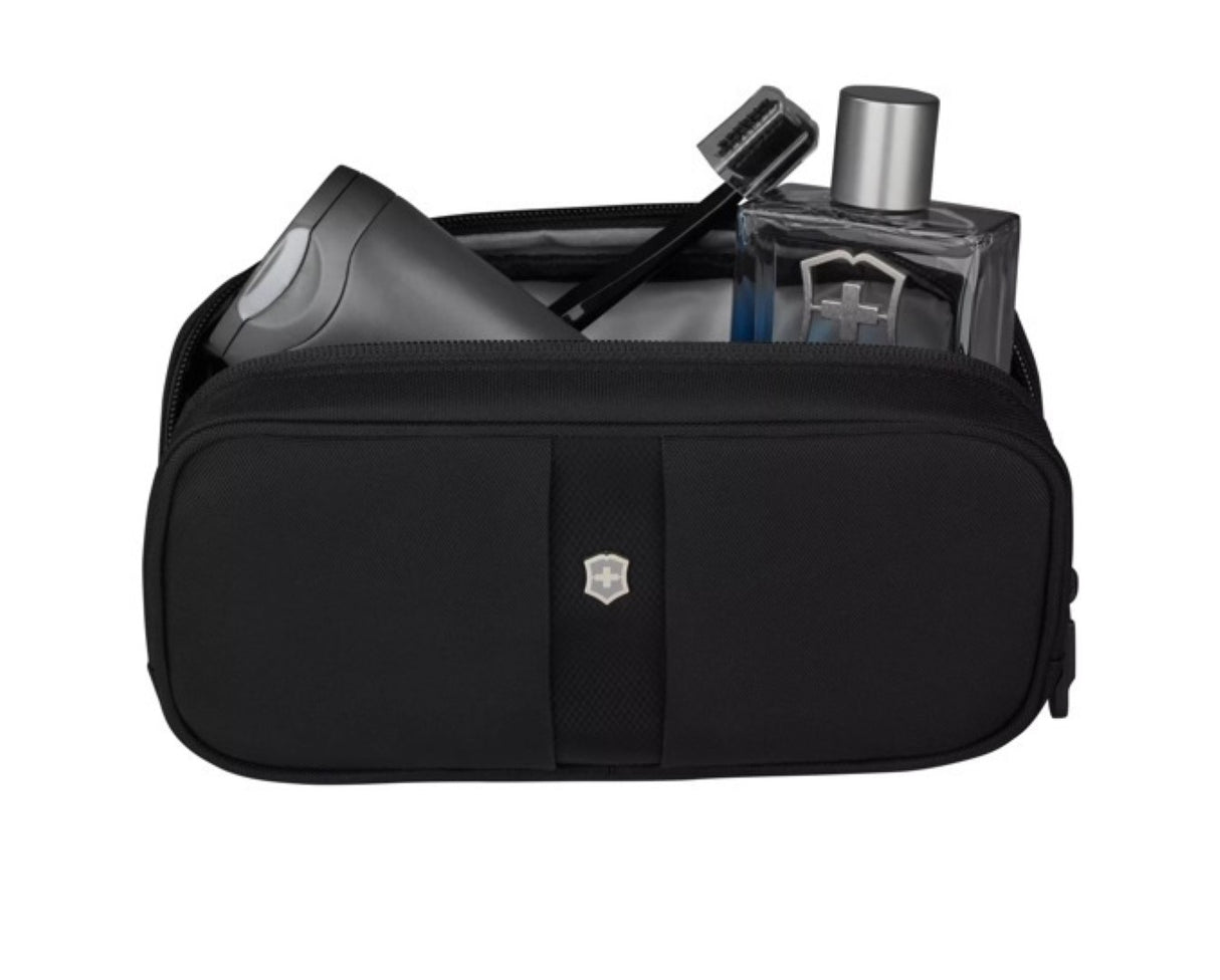 Compact black toiletry kit with antibacterial lining and micro-mesh pockets for organized travel essentials.