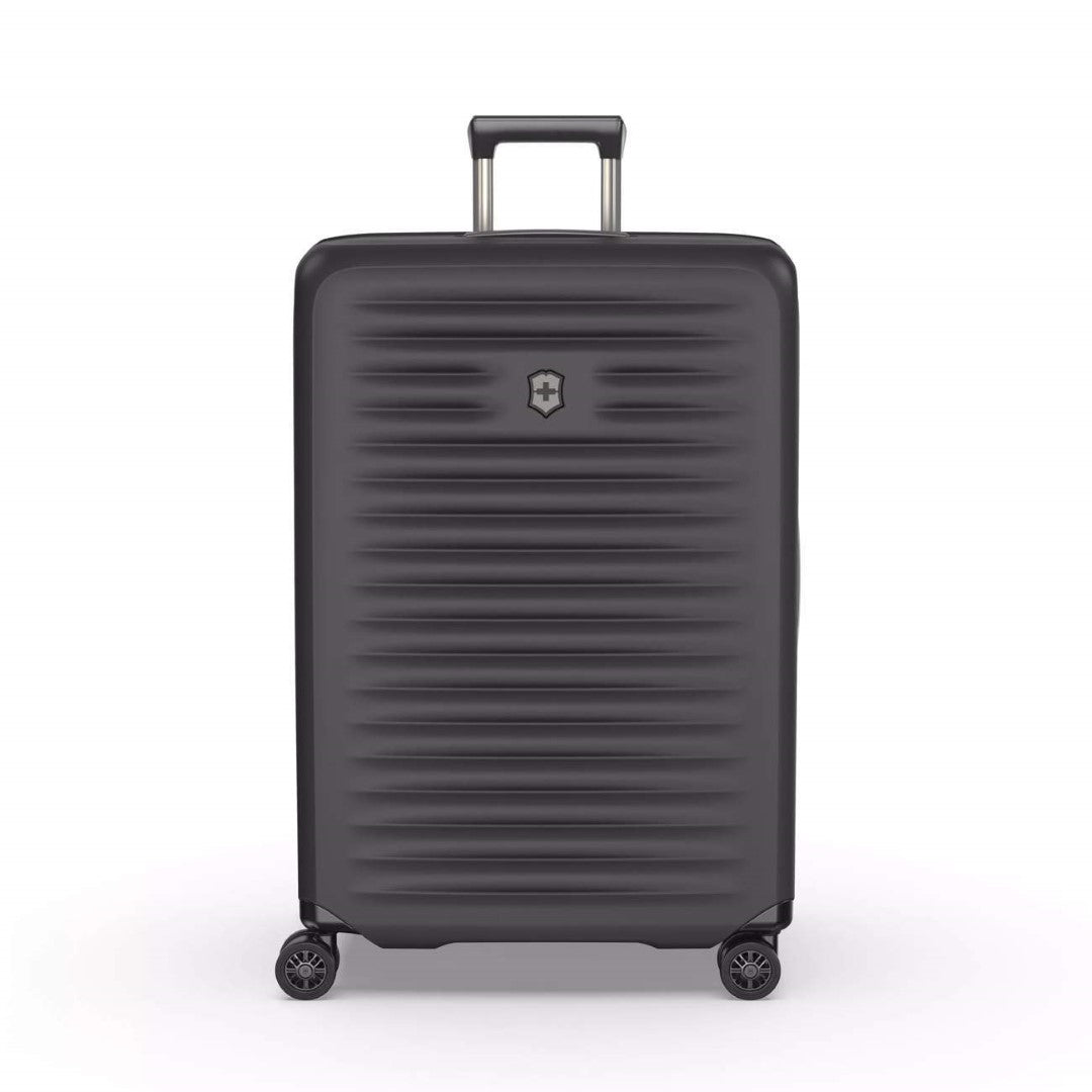 Hardside black travel case with expandable capacity, compression straps, and 4 spinner wheels for easy maneuverability.