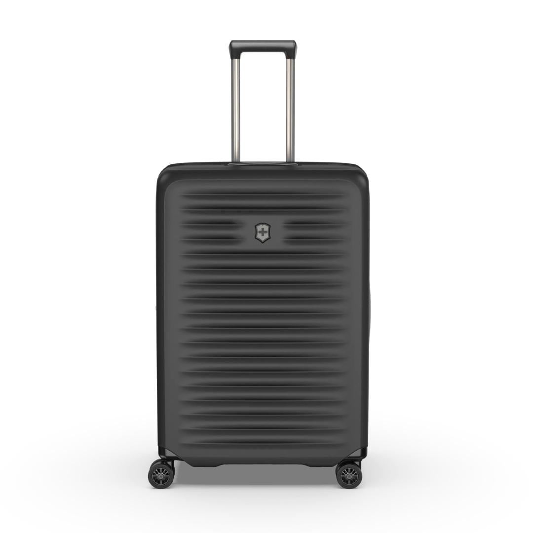 Lightweight black hardside case with expandable capacity, featuring compression straps and a sleek design for travel flexibility.