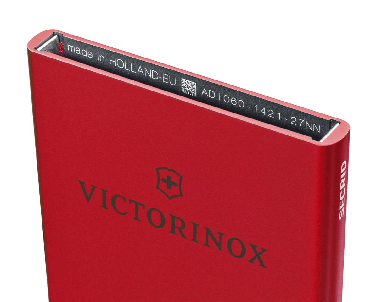 Red aluminum Essential Card Wallet by VICTORINOX, storing 4-6 cards with RFID protection and quick-access sliding system.