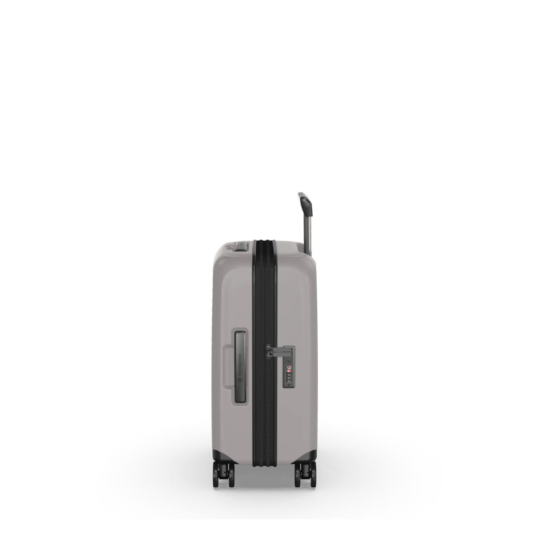 Lightweight white hardside carry-on suitcase with expandable capacity, anti-scratch pocket for devices, and smooth-rolling wheels.