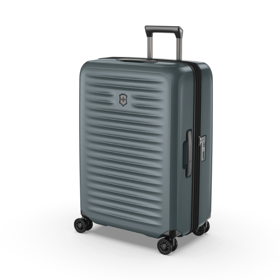 Medium hardside suitcase in Storm color, featuring durable polycarbonate, expandable design, and smooth 4-wheel spinner system.