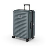 Medium hardside suitcase in Storm color, featuring durable polycarbonate, expandable design, and smooth 4-wheel spinner system.