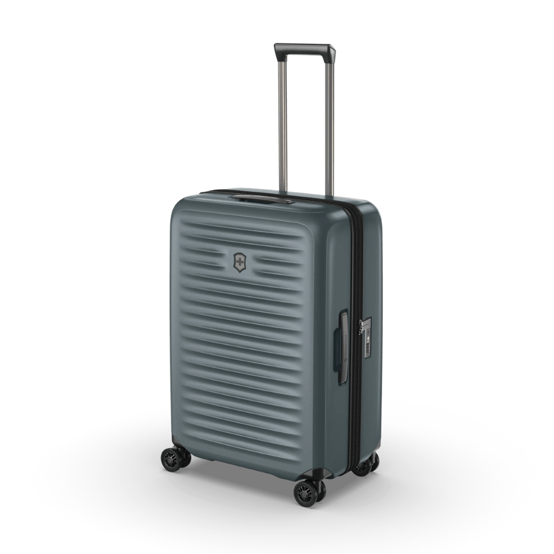 Lightweight polycarbonate hardside suitcase in Storm, featuring compression straps and 4-cm expansion for flexible travel.