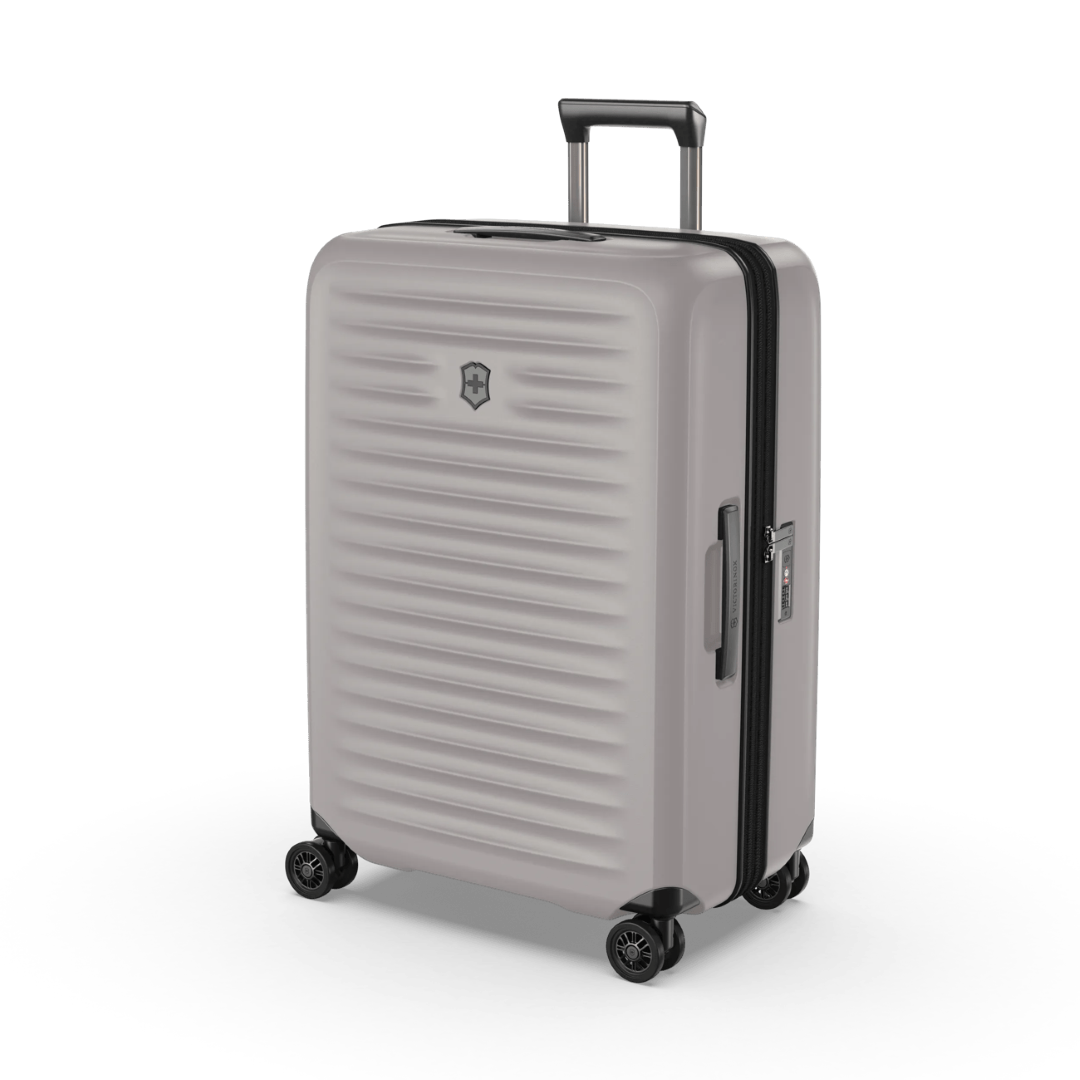 Sleek white VICTORINOX Airox Advanced Medium Hardside Case with 4-wheel spinner, expandable capacity, and secure compression straps.