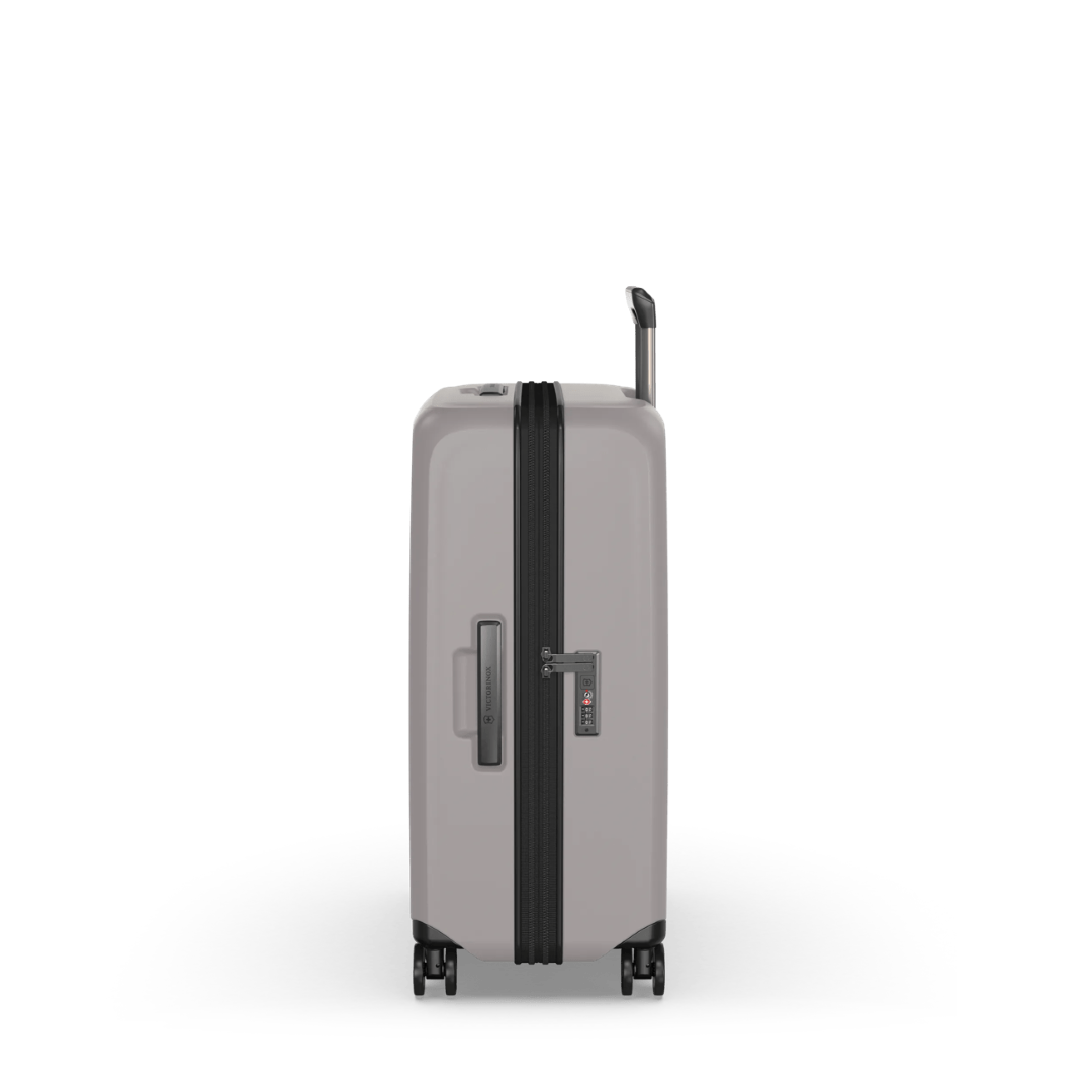 Sleek white VICTORINOX Airox Medium Hardside Case with expandable capacity, dual caster wheels, and compression straps for secure packing.