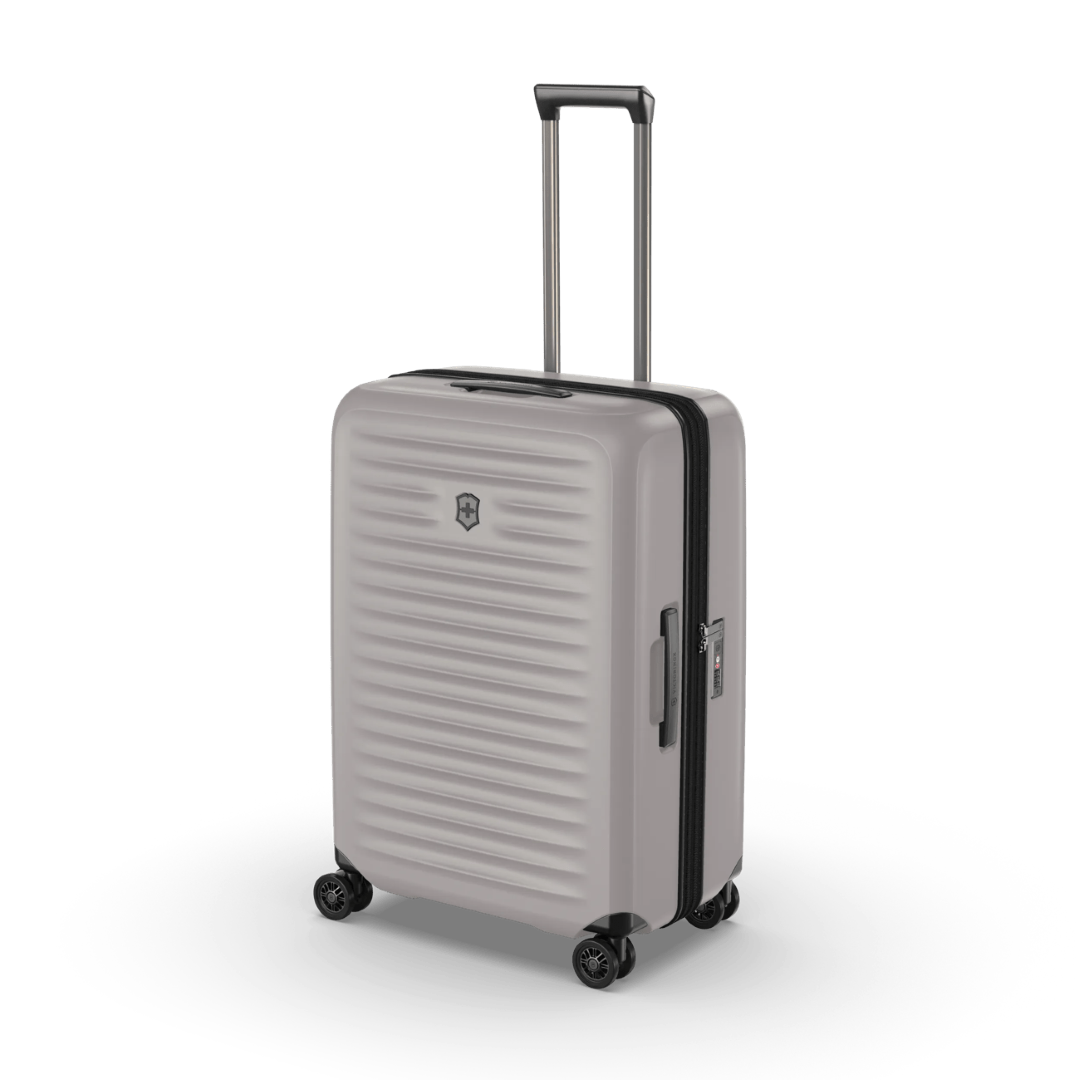 Sleek white VICTORINOX Airox Advanced Medium hardside case with expandable capacity and smooth 4-wheel mobility.