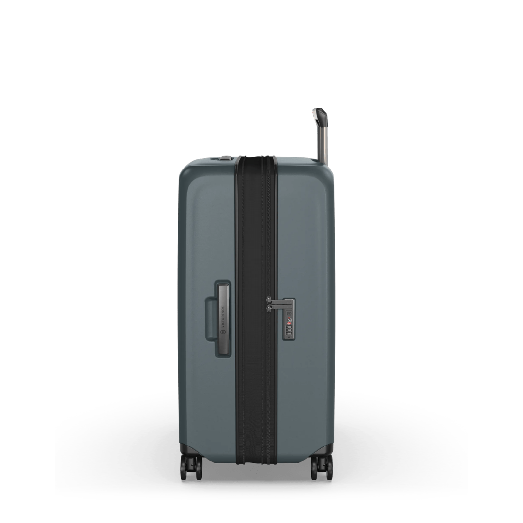 Airox Advanced Large Hardside Case in Storm green, featuring elastic straps, expandable capacity, and smooth spinner wheels for travel.