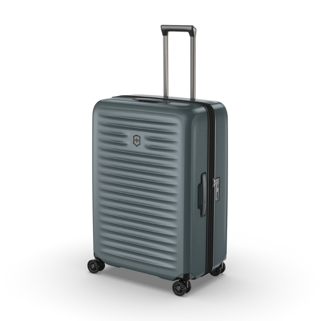 Hardside green polycarbonate suitcase with expansion system, X-shaped straps, and 4 dual-caster wheels for effortless travel.