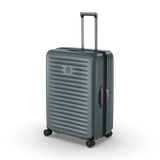 Hardside green polycarbonate suitcase with expansion system, X-shaped straps, and 4 dual-caster wheels for effortless travel.