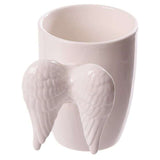 Ceramic mug with a whimsical white angel wings handle, ideal for tea, coffee, or as a decorative piece, 380ml capacity.