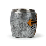 Decorative medieval knight tankard featuring a silver and gold helmet, made of resin and stainless steel, 14cm wide.