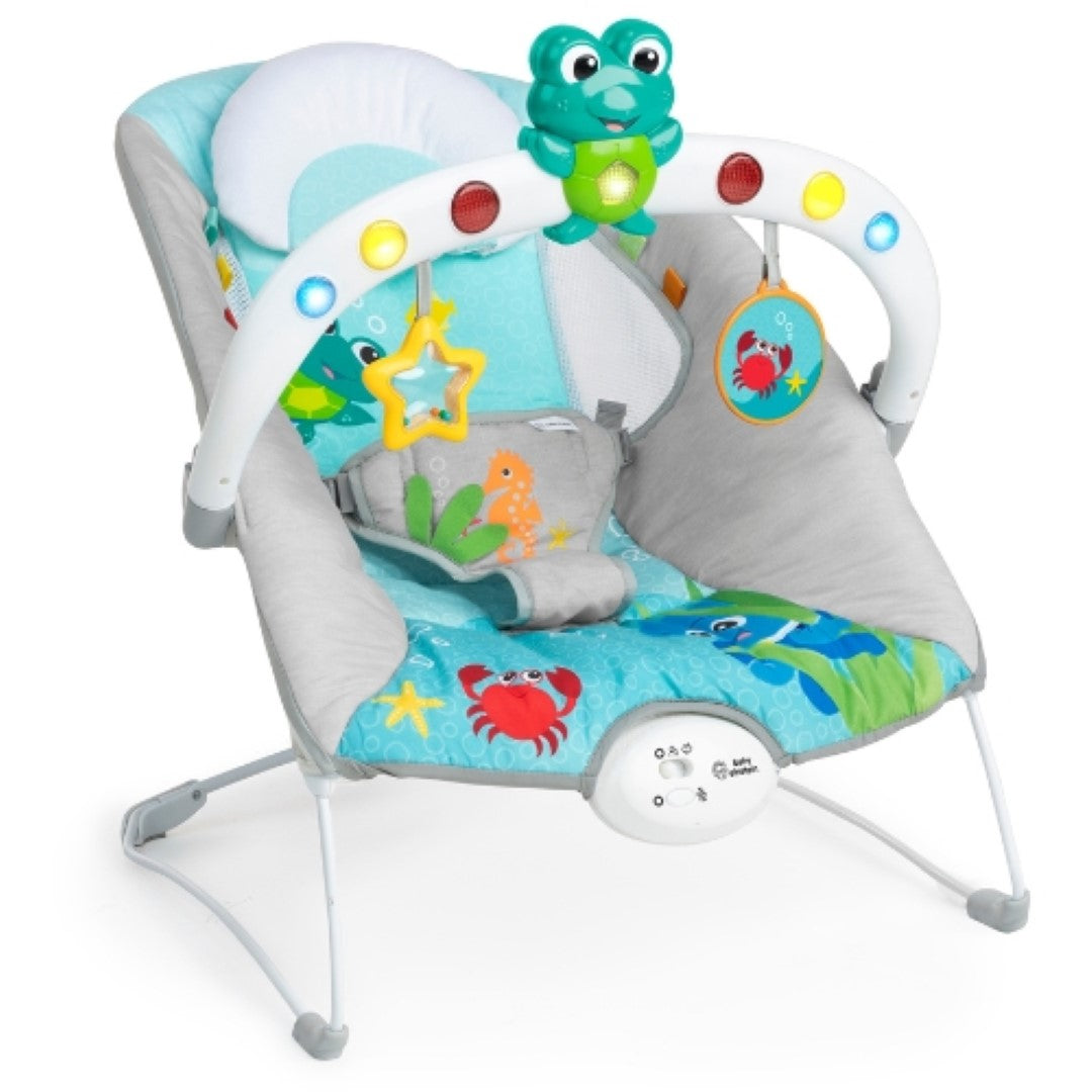 Musical bouncer for babies, featuring ocean sounds, lights, and interactive toys for sensory exploration and motor skill development.